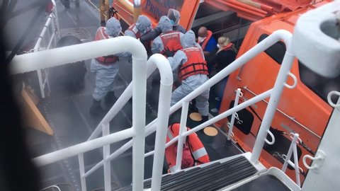 CIRCA 2020 - iPhone footage of sick coronavirus Covid-19 victims being removed from Princess Cruise ship by Coast Guard emergency crisis personnel.