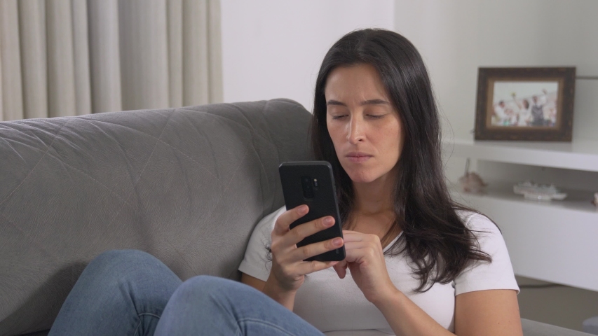 Thoughtful concerned woman on cellphone looking away thinking solving problem at home, serious woman search for inspiration make decision feel lack of ideas, close up view
 Royalty-Free Stock Footage #1049981239