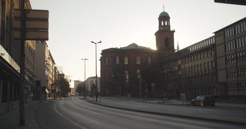 Covid-19 pandemic lockdown. Frankfurt, Germany. April 5, 2020. Empty Berliner Street and sun rising behind St. Paul's church.