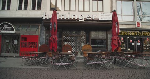 Covid-19 pandemic lockdown. Frankfurt, Germany. April 5, 2020. Street cafe tables with barricade tape and closed restaurants during pandemic lockdown.