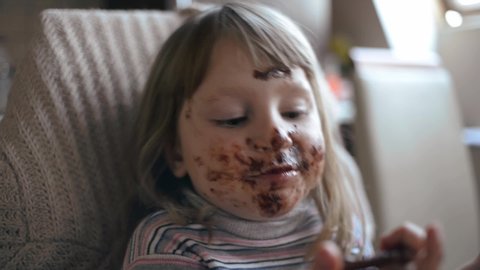 Little Girl with Chocolate on a Face funny eats Sweet Dessert