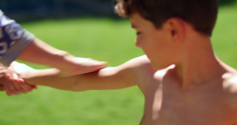 Mother applying sunscreen to child son outside during summer holiday vacations
