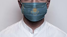 Stop motion video male face covered with a protective medical mask, painted in world flag colors. Corona virus pandemic. Concept of Corona virus quarantine, Covid-19