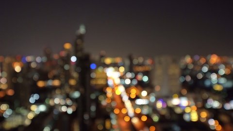 Bokeh background of skyscraper buildings in Bangkok city, Thailand with lights, Blurry photo at night time. Cityscape