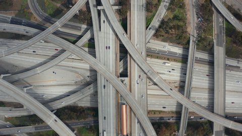 AERIAL: Spectacular Overhead follow Shot of Judge Pregerson Highway showing multiple Roads, Bridges, Viaducts with little car traffic in Los Angeles, California on Beautiful Sunny Day 