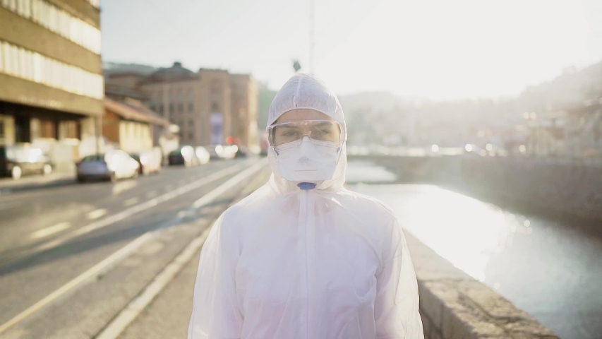 Disinfection service worker in hazmat suit with N95 mask and protective glasses.Private protective equipment (PPE).Quarantined area decontamination.Protective clothing. COVID-19 corona virus doctor | Shutterstock HD Video #1049997670