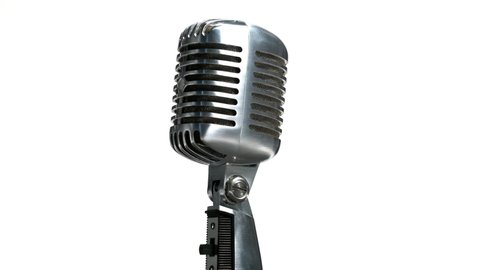 Closeup of retro microphone rotating on white background