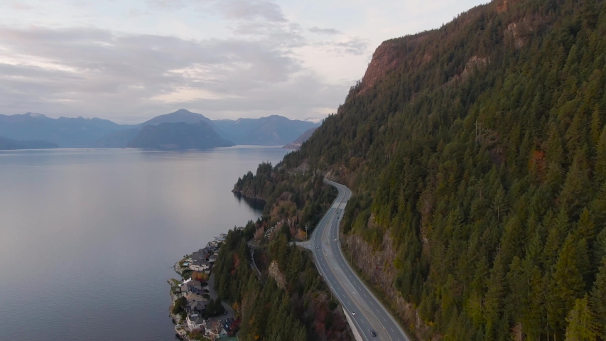 Sea to Sky Hwy in Howe Sound near Horseshoe Bay, West Vancouver, British Columbia, Canada. Aerial panoramic view during a colorful sunset in Fall Season. Royalty-Free Stock Footage #1050034915