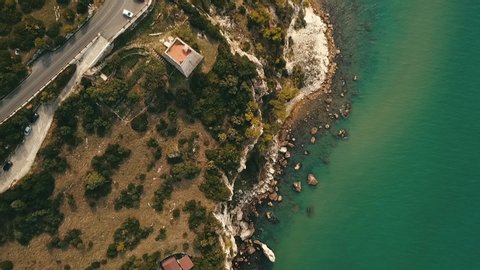 Top-down perspective of mediterranean coastline,point and parking spot near Gargano, Italy