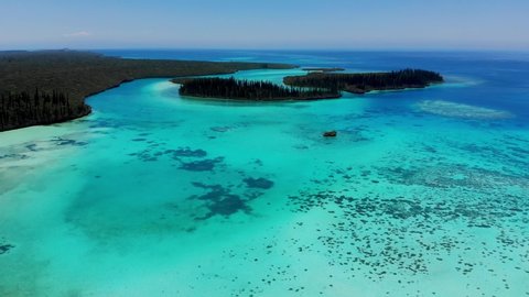Aerial drone footage of Gadji and Crabes Bay located at the north end of the Isle of Pines in New Caledonia. The area is full of small beaches and numerous islets.