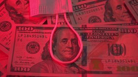 Noose for Benjamin Franklin. 100 dollar bill in a loop. The global economic crisis. A medical mask lies on dollars. Pandemic virus. Financial crisis. Red color, danger. Unemployment. COVID-19 - Powered by Shutterstock - Get 15% off with code: PIKWIZARD15