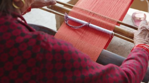 Multi Shot. Women Weaving Yarn with Traditional Loom in Nepal