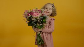 Excited kid holding flowers, jumping and dancing with smile