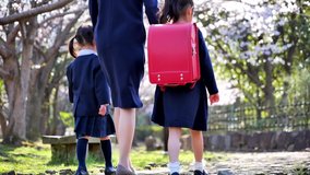 Japanese parents and children going to elementary school entrance ceremony