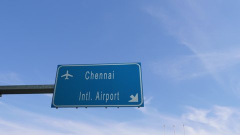 chennai airport sign airplane passing overhead 