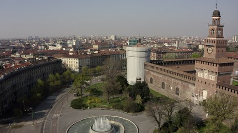 Everyday life in Milan, Italy during COVID-19 epidemic. Milano, Italian city and coronavirus lockdown. Aerial view of monument: Castello Sforzesco seen from drone flying in sky