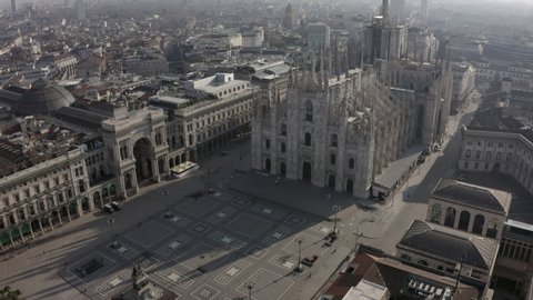 Daily life in Milan, Italy during COVID-19 pandemic. Milano, Italian city and coronavirus outbreak. Aerial view of Piazza Duomo. Historic monument and religious building seen from drone flying in sky