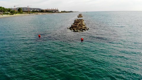 Stationary Static Drone Shot Hovering Over the Water with Beautiful Rocks in Limassol, Cyprus