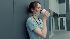 Portrait of tired exhausted nurse or doctor having a coffee break outside in the morning. COVID-19, Coronavirus pandemic. ARRI Alexa Mini - Powered by Shutterstock - Get 15% off with code: PIKWIZARD15