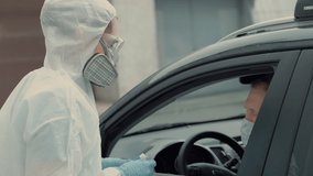 Patient is being tested in his vehicle on a drive-through coronavirus COVID-19 testing location. Pandemic, infection - Powered by Shutterstock - Get 15% off with code: PIKWIZARD15