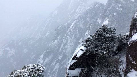 Rare snowing in HuangShan Unesco World Heritage site in Anhui China, heavy snowfall in Yellow Mountain scenic park in winter