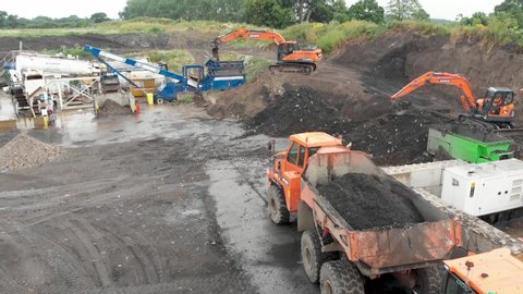 Escrick, York UK: 19th July 2019: Aerial footage of the Waste Recovery Park located in the town of York in the UK showing diggers putting rubbish and dirt into a dumper truck