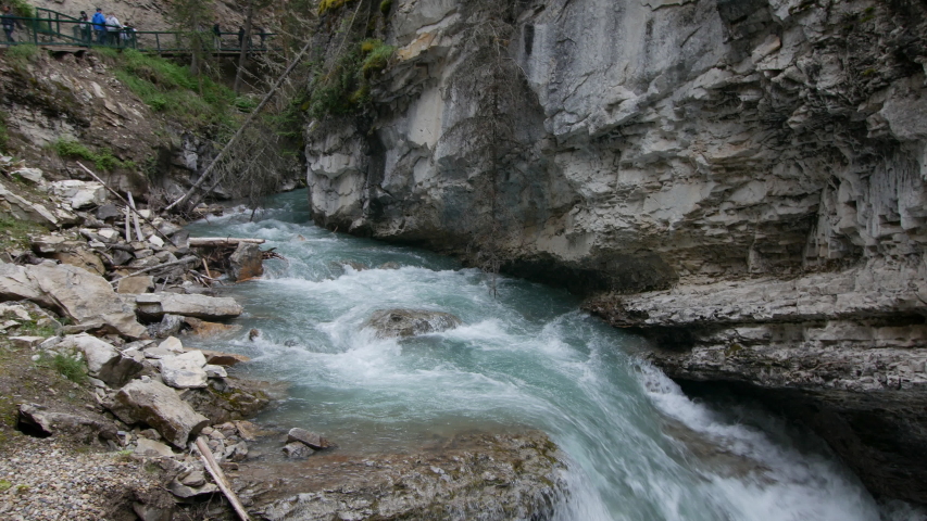Pan of river running through Johnston Canyon in Alberta with whitewater