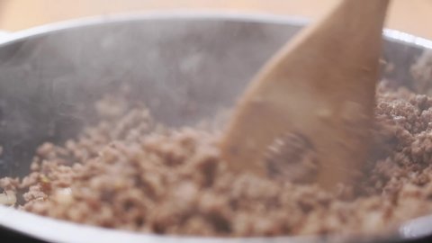 Frying mince in a pan, slow motion.