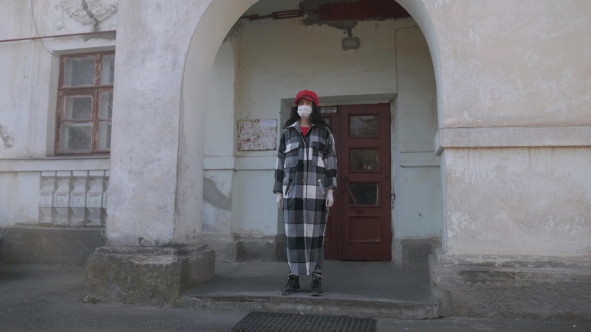 Girl in a medical protective mask. Virus epidemic in the city. Coronavirus. Pandemic of a dangerous disease in the world.