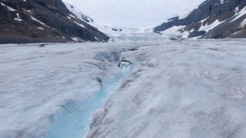 Clear glacier melt running down the face of the glacier with vibrent blue colour