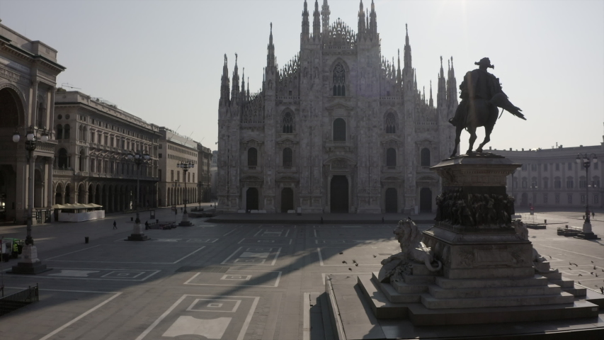 Everyday life in Milan, Italy during COVID-19 epidemic. Milano, Italian city and coronavirus lockdown. Aerial view of Piazza Duomo with cathedral seen from drone flying in sky | Shutterstock HD Video #1050112408