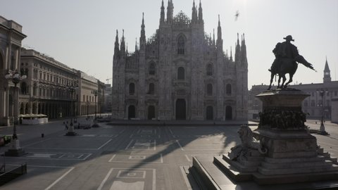 Everyday life in Milan, Italy during COVID-19 epidemic. Milano, Italian city and coronavirus lockdown. Aerial view of Piazza Duomo with cathedral seen from drone flying in sky