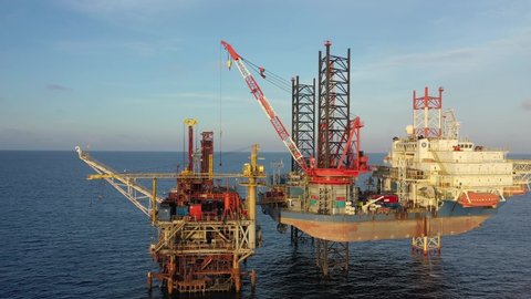 TERENGGANU, MALAYSIA - FEBRUARY 16, 2020: Self-elevating liftboat and oil production platform in Malaysian Waters with beautiful sunset sky.