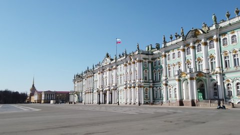 HD hyper-lapse video of Saint Petersburg's Hermitage Winter Palace, sunny day Russian flag on top of Historical building on Palace Square, empty streets during covid-19 quarantine