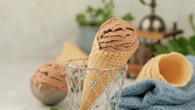 Delicious summer dessert coffee ice cream in waffle cone. Summertime healthy food concept, lactose free. Camera zoom out