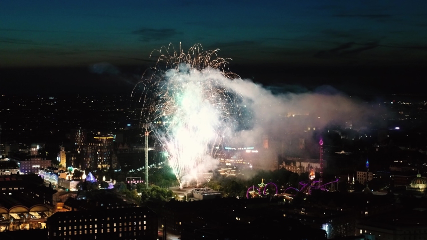 Giant fireworks over Tivoli Gardens in the center of Copenhagen, Denmark. Footage is taken from high above by a drone. Drone stock footage video by DroneRune