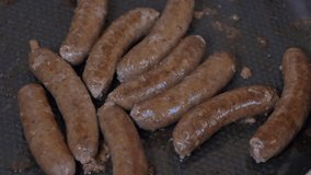 Close up shot of sausages and on the grill - Grilling sausages, cooking. Grilling food, bbq, barbecue, 4k