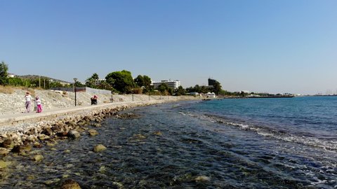 Low Flying Drone Shot Scanning Across the Rocky Shore Near a Pedestrian Path in Limassol, Cyprus