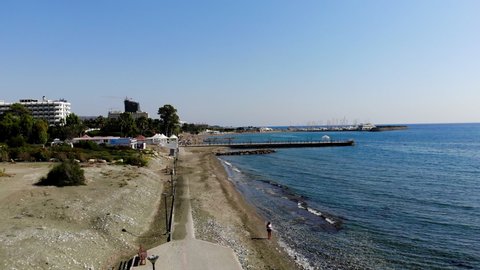Aerial Shot Ascending High Over The Beach Front in Limassol, Cyprus Revealing the Vast Landscape in the Distance