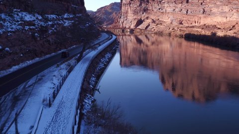 Aerial Drone Footage Flyover of Colorado River and Reflections Near Moab, Utah U.S.A. in Winter Approaching Bridge on Highway 191