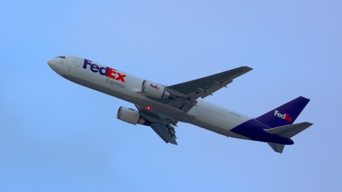 UNITED STATES - 2020: FedEx Express Boeing 767-300 Air Freighter Airplane Taking off and Flying Cargo into a Cloudy Sky