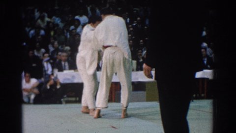 WEST COVINA CALIFORNIA-1966: Two Men A Red Belt And A Black Belt Tussle During A Martial Arts Tournament