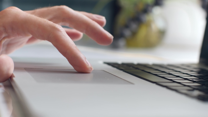 Close up shot of man's hand scrolling a Website Using Laptop Track Pad. Royalty-Free Stock Footage #1050207583