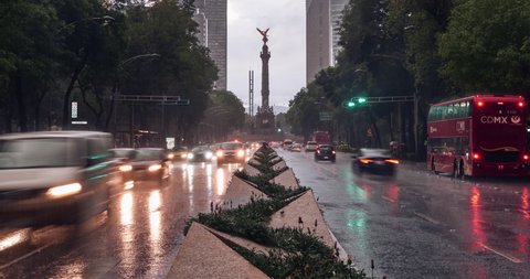 Motionlapse of Paseo de la Reforma under the rain at evening with Angel of Independence in background, Mexico City, in March 9, 2020.