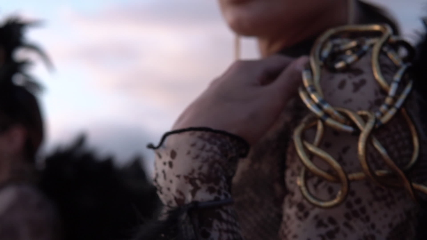 Young woman with costume as Gorgon Medusa, lizard, shake dance in desert. Slow motion 100fps. Apple ProRes 422 HQ