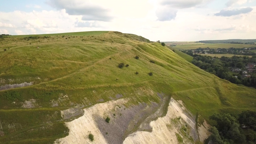 Aerial view of a hill side with big rocky slope from gravel stones.