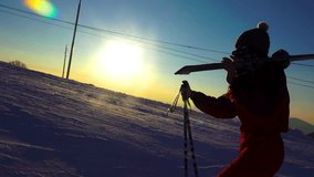 4K Silhouette of a woman with ski in winter mountains sunset close up. UHD steadycam stock video