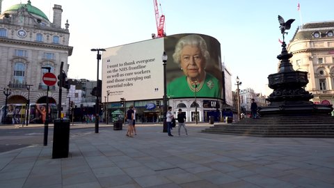 LONDON, UK - April 11th 2020: Queen Elizabeth II of England, Thank you NHS, COVID-19 corona virus pandemic, Stay Home, Save Lives, screen sign information panel message, Piccadilly circus, London