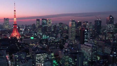 Cityscape of Tokyo skyline at dusk, aerial panorama view of city downtown, zoom in. 4K time lapse