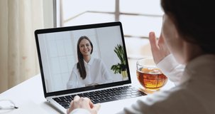 Online teacher and student, distance worker with manager or coach and client having distance chat video calling in app on laptop screen. Webcam job interview, training. Over shoulder closeup view